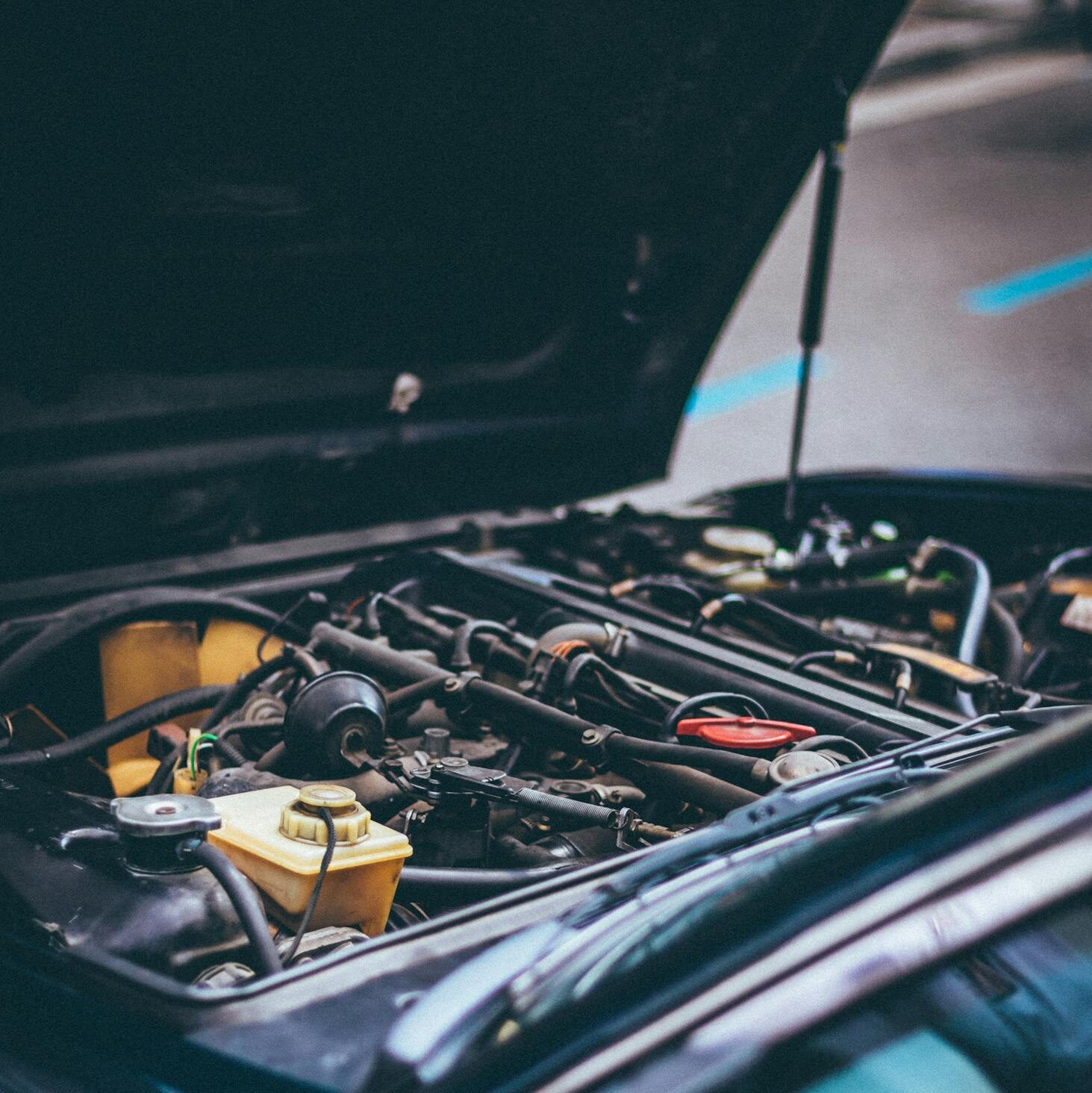 Detailed view of an exposed car engine under maintenance in Barcelona.
